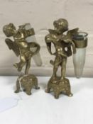 A pair of cast brass cherub posy stands