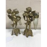 A pair of cast brass cherub posy stands