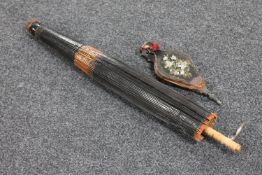 A bamboo handled Chinese parasol and a small set of antique wooden bellows