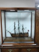 A model ship, Resolution, in glazed mahogany display cabinet,