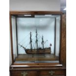 A model ship, Resolution, in glazed mahogany display cabinet,