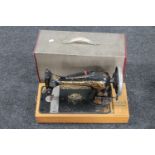A vintage cased Singer hand sewing machine (electric)