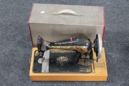 A vintage cased Singer hand sewing machine (electric)