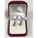 A pair of 9ct gold diamond set earrings with post fittings