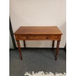 A Victorian mahogany writing table fitted a drawer,