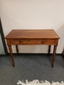 A Victorian mahogany writing table fitted a drawer,