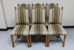 A set of six continental oak dining chairs in beige striped fabric