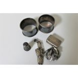 Two sterling silver napkin rings together with a thimble stamped 925,