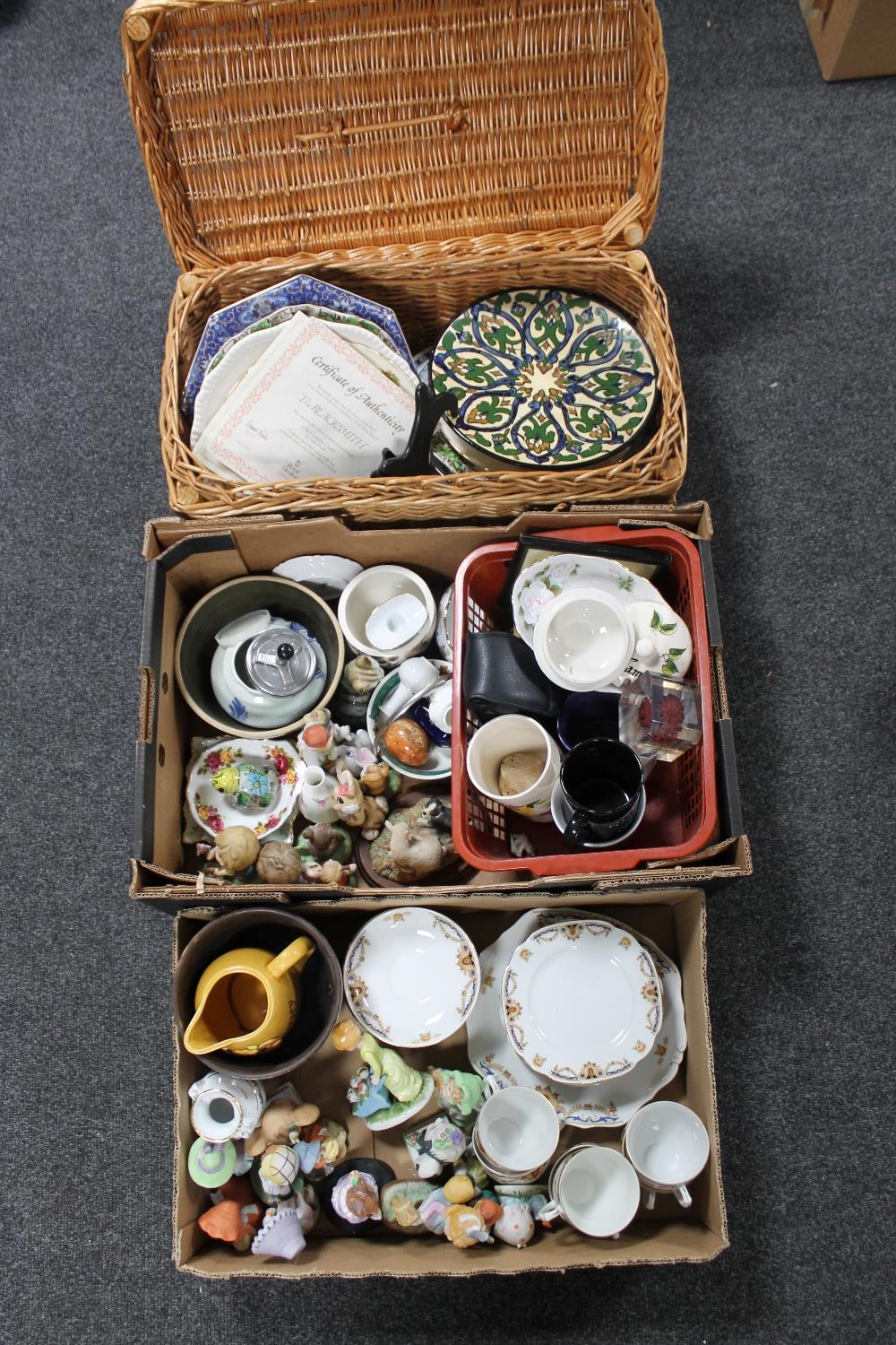 Two boxes and a wicker basket of tea china, figurines, wall plates,
