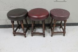 Three pub stools upholstered in leather