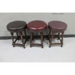 Three pub stools upholstered in leather