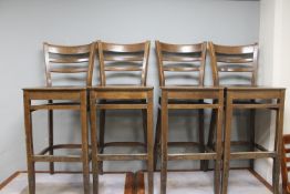 A set of four wooden bar chairs