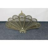 A 20th century brass fan fire screen