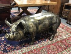 A cast patinated aluminium figure - pig,