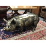 A cast patinated aluminium figure - pig,