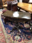 An Edwardian mahogany carved tea table on pedestal support
