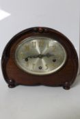 An early 20th century mahogany cased mantel clock with silvered dial