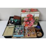 A tray of four drawer jewellery chest and costume jewellery,