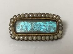 A Georgian yellow gold memoriam brooch dated 1816 set with split pearls