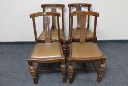 Four 1930's carved oak dining chairs (one damaged)