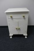 A white painted cabinet fitted a drawer
