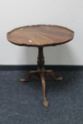 A mahogany tilt top wine table on claw and ball feet