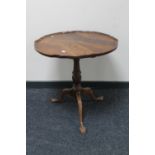 A mahogany tilt top wine table on claw and ball feet