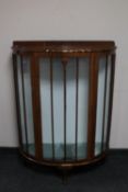 An early 20th century mahogany D-shaped display cabinet