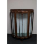 An early 20th century mahogany D-shaped display cabinet