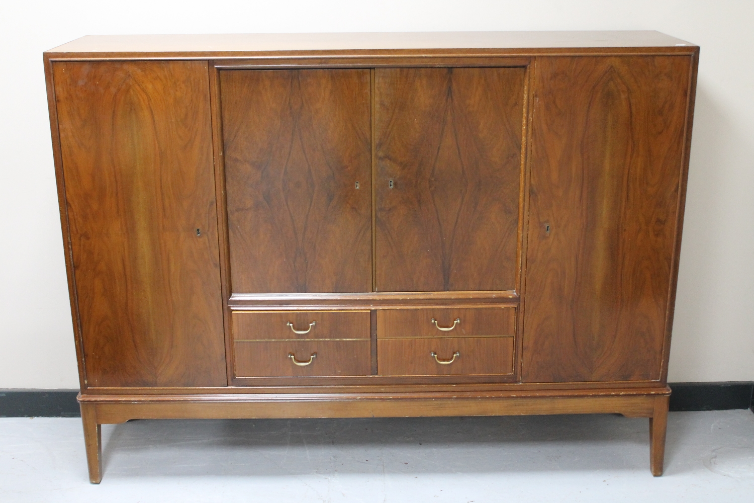 A mid 20th century walnut four door sideboard