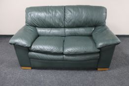 A green leather two seater settee