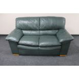 A green leather two seater settee