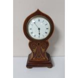 An early 20th century inlaid mahogany balloon shaped mantel clock