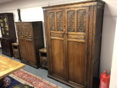 An early 20th century carved oak four piece bedroom suite comprising two wardrobes and pair of