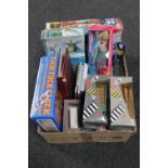 A box containing die cast vehicles, Barbie dolls,