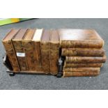 An oak Art Deco book trough together with twelve volumes of British Encyclopaedia