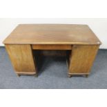 A mid 20th century continental walnut twin pedestal writing desk