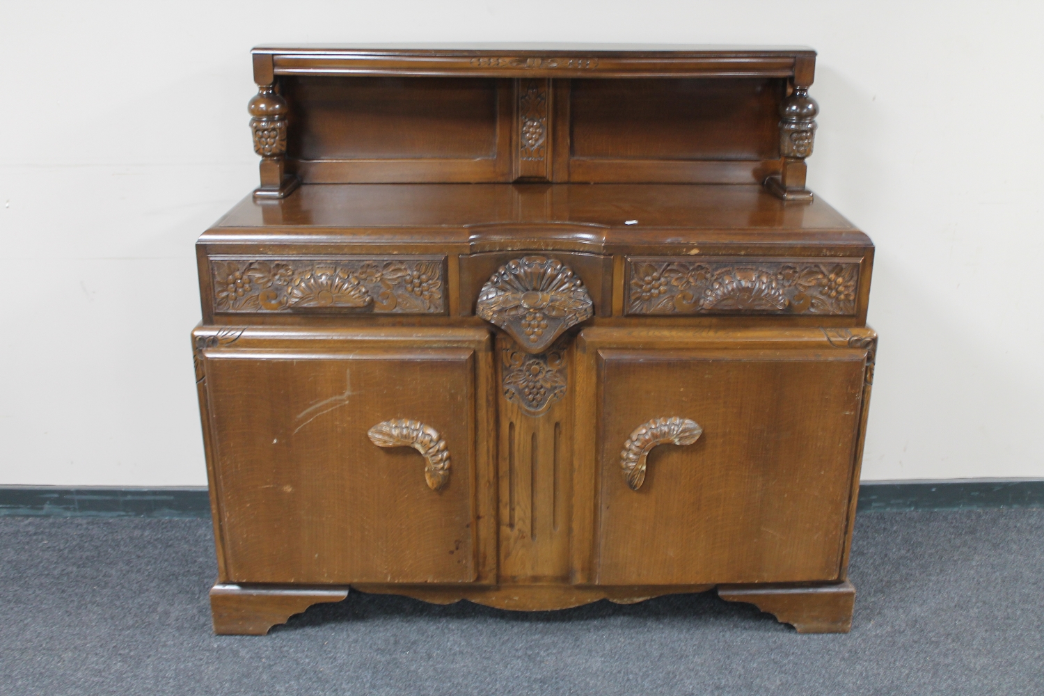 A 1930's carved oak buffet back sideboard