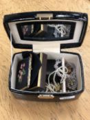 A jewellery box containing costume jewellery, china posie brooches, necklaces, earring and necklace,