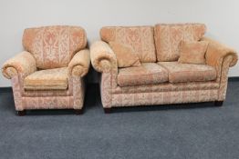 A two seater settee and matching armchair upholstered in a classical print