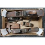 A box of seven assorted woodworking planes