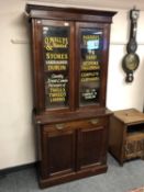 An Edwardian and later glazed bookcase with advertising decoration,
