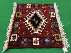 A fringed Caucasian design mat,