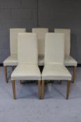 A set of five cream leather high back dining chairs