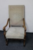 A 20th century continental oak scroll arm armchair
