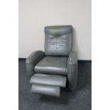 A grey leather manual reclining armchair