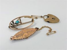 A 9ct gold brooch together with a 9ct heart padlock and brooch, 6.8g gross.