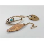 A 9ct gold brooch together with a 9ct heart padlock and brooch, 6.8g gross.