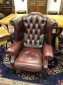 An oxblood leather Chesterfield wingback armchair,