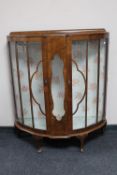 A 1930's walnut D-shaped display cabinet